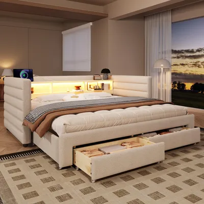 A bedroom scene with a bed, nightstand, and window with a sunset view.