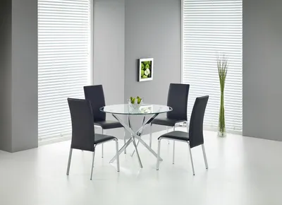 A dining table with four chairs in a modern room.