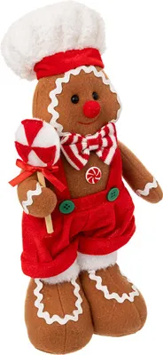 A plush gingerbread man decoration holding a lollipop.
