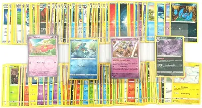 A collection of Pokémon cards spread out on a white background.