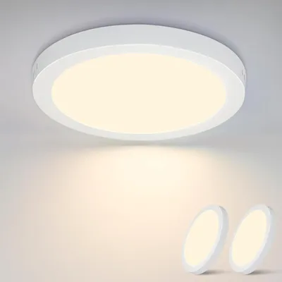A white LED ceiling light is shown mounted on a white ceiling, with two smaller, similar lights placed on a white surface below.