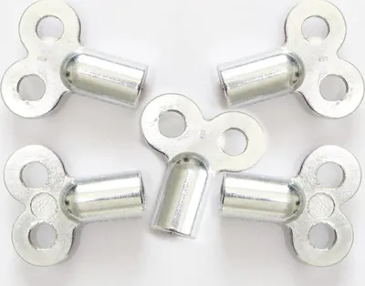 A top-down view of five silver radiator keys on a white background.