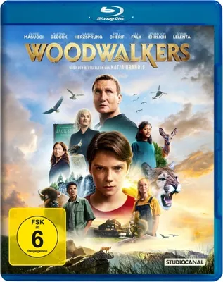 The image is a Blu-ray disc cover for the movie 'Woodwalkers', featuring a collage of characters and animals against a sky background.
