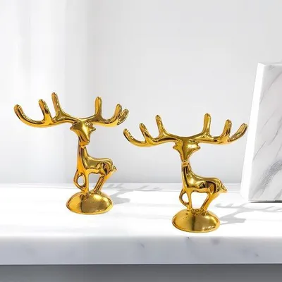Productafbeelding van Unyqoos® Set (2 stuks) gouden hertenornamenten – staande decoratieve figuren, 6,9 × 6,4 cm, voor woonkamerdecoratie en als sieradenhanger