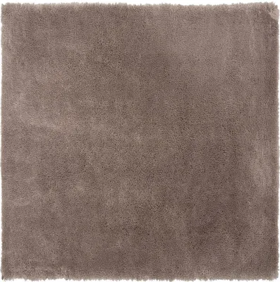 A close-up, top-down view of a square, shaggy rug in a light brown color.