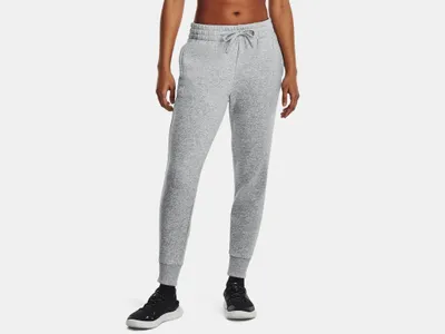 A person is wearing grey sweatpants and black sneakers.