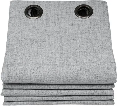 A stack of folded gray curtains with grommets at the top.