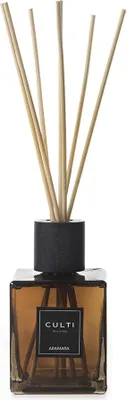 A diffuser with reeds in a glass bottle.