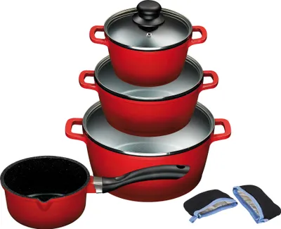A set of red pots and pans stacked on top of each other, with a small saucepan to the side and two oven mitts at the bottom right.