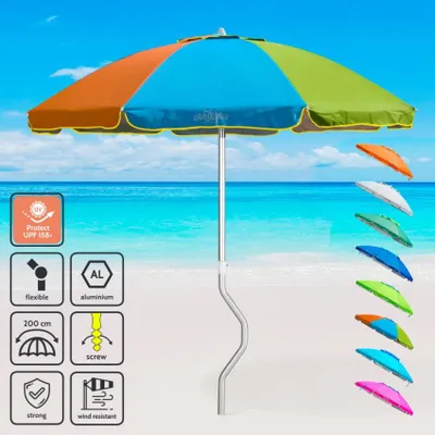 A beach umbrella on a sandy beach with the ocean and sky in the background.