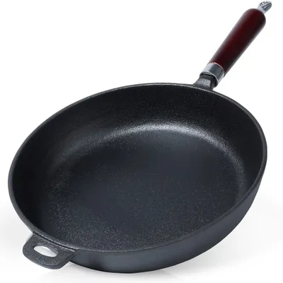 A black cast iron frying pan with a wooden handle is shown against a white background.