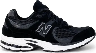 A black New Balance 2002R sneaker is shown from the side on a white background.
