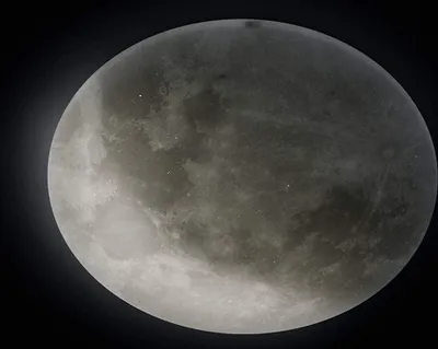 A close-up view of the moon against a black background.