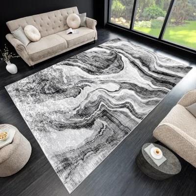 A modern living room with a sofa, rug, and coffee table.