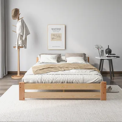 A bedroom scene with a bed, a coat rack, and a side table.