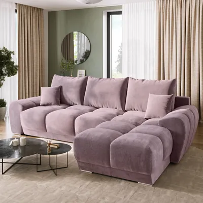 A modern living room with a large sectional sofa, coffee table, and curtains.
