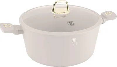 A cream-colored pot with a glass lid and gold accents, shown from a side angle against a white background.