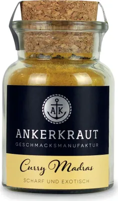 A glass jar of curry powder with a cork lid and a label.