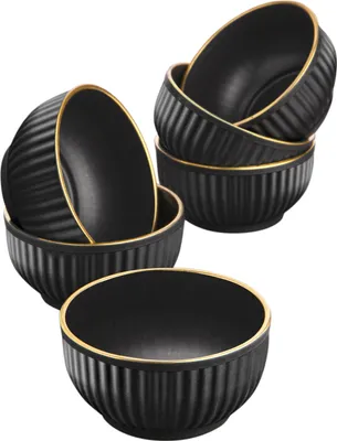 A set of black ceramic bowls with gold trim, arranged in a group.