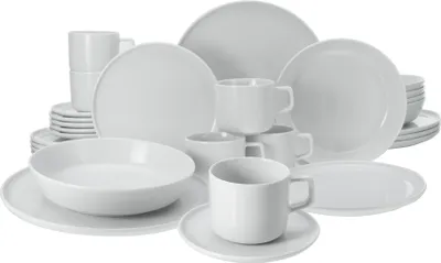 A collection of white ceramic dishes and cups arranged on a white background.