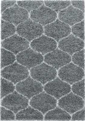 A close-up view of a gray rug with a geometric pattern.