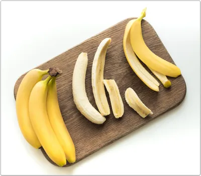 Produktbild von Spritzschutz Herdabdeckplatte Schneidebrett aus Glas Bananen auf Brett 1-Teilig (60x52cm)