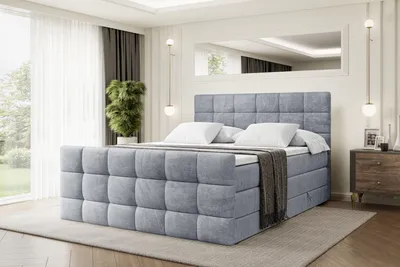 A bedroom scene featuring a large, upholstered bed.