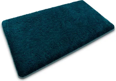 A single teal bath mat is shown from a diagonal angle on a white background.