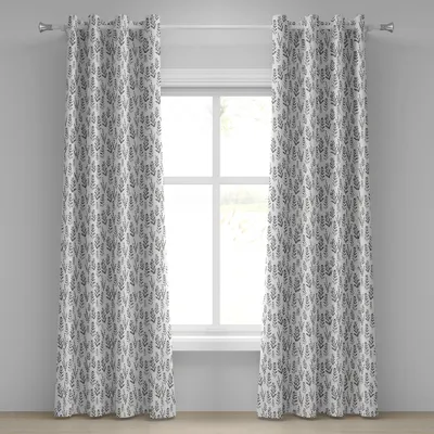 Two curtains with a botanical pattern hang on a curtain rod in front of a window.