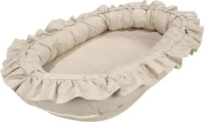 A baby nest with ruffled edges on a white background.