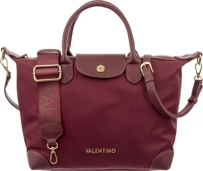 A studio shot of a burgundy handbag.