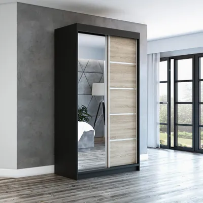 A modern bedroom with a sliding door wardrobe.