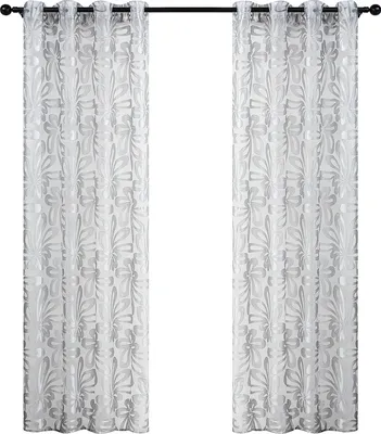 Two sheer curtains with a floral pattern hanging on a curtain rod.