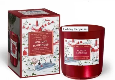 A red scented candle with a holiday-themed label and its matching box are displayed on a white background.
