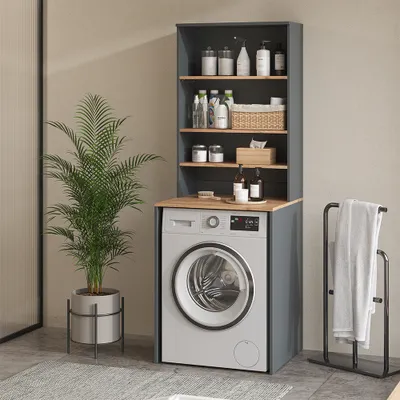A washing machine with a storage unit above it, in a laundry room setting with a plant and towel rack.