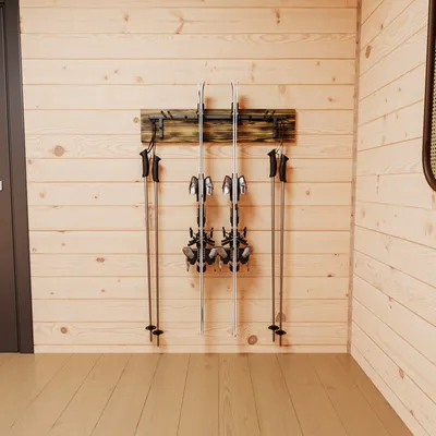 A wall-mounted ski rack holding skis and poles.
