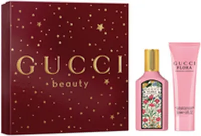 A Gucci beauty gift set with a box and two perfume bottles.