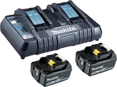 A black dual battery charger with two Makita 18V 5Ah batteries in front of it.
