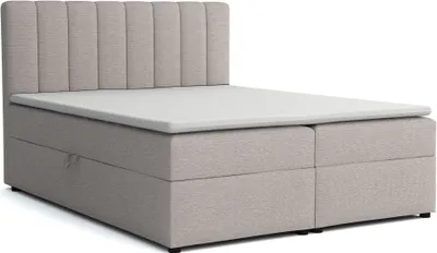 A light grey upholstered bed frame with a padded headboard and a white mattress topper, shown against a white background.