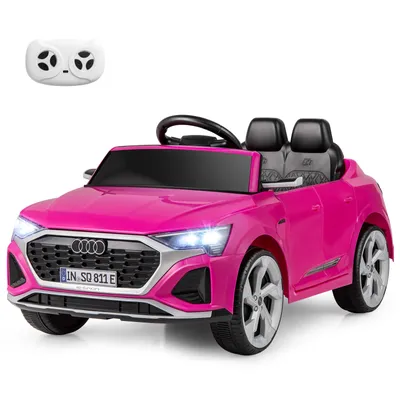 A pink Audi SQ8 electric toy car with a remote control.