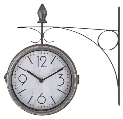 A vintage-style double-sided station clock mounted on a decorative metal bracket.