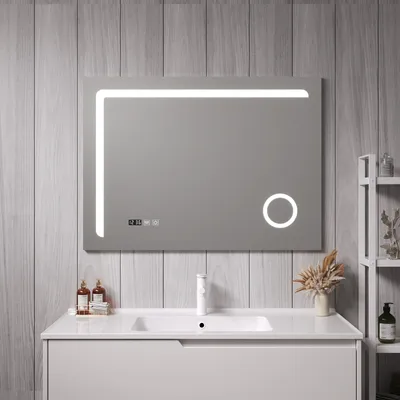 A modern bathroom vanity with a sink and a large LED mirror.