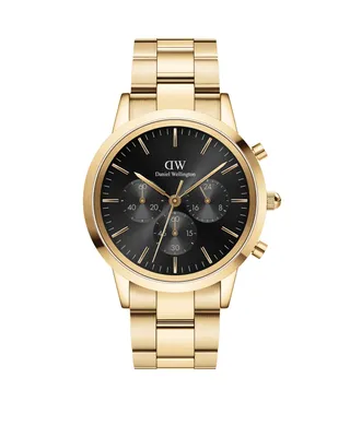 A studio shot of a gold Daniel Wellington watch with a black face.