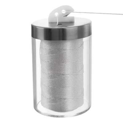 A close-up studio shot of a kitchen twine dispenser with twine inside.