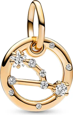 A close-up studio shot of a gold-colored charm with clear stones, shaped like a constellation.