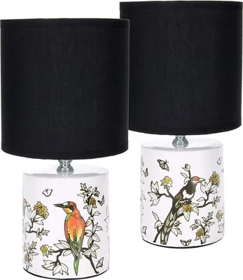 Two table lamps with black shades and ceramic bases decorated with birds and butterflies.