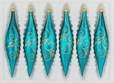 Six teal glass Christmas ornaments with gold scrollwork, arranged in a white tray.