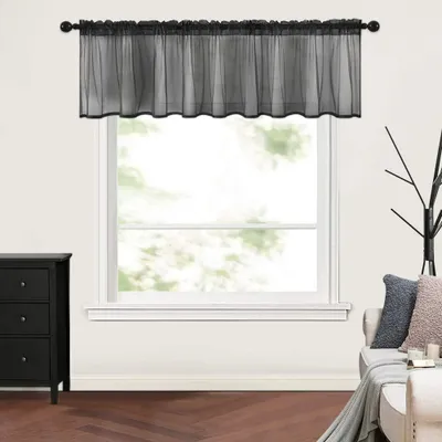 A black valance is shown hanging from a curtain rod above a window.