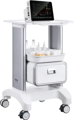 A medical cart with a monitor on top, a tray of bottles, and a drawer.
