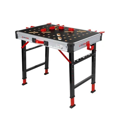 A folding workbench with red clamps on its surface, set against a white background.